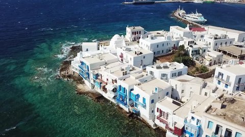 Aerial drone video of iconic little Venice and church of Paraportiani in hora of Mykonos island, Cyclades, Greece