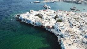 Aerial drone bird's eye view video of iconic little Venice and church of Paraportiani in chora of Mykonos island, Cyclades, Greece