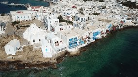 Aerial drone bird's eye view video of iconic little Venice and church of Paraportiani in chora of Mykonos island, Cyclades, Greece
