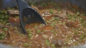 Close-up of stew with pork meat and peas slow-mo video