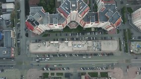 Residential district in a large metropolis with road junctions and houses. Video. View of a newly built residential complex with a shopping center on the lower floors. Aerial view