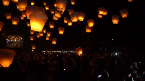 Taipei, Taiwan-02 March, 2018: 4K People launching many asian fire lanterns during buddhist festival in chinese new year. Rice paper hot air balloons floating in traditional flying sky lantern-Dan