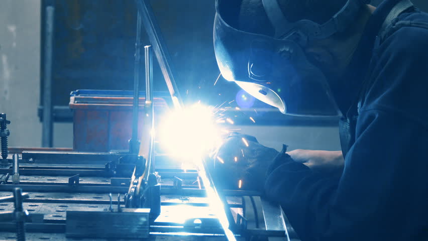 Welder worker welds metal accessories on the factory | Shutterstock HD Video #1010540354