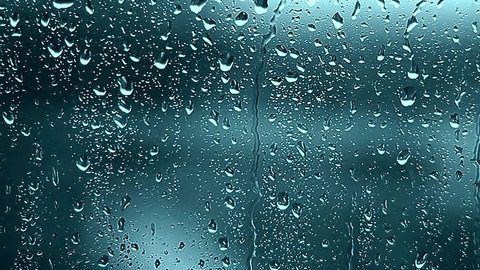 Close-up of water droplets on glass, Rain Rain, Go Away. Large rain drops strike a window pane during a summer shower. 4K.