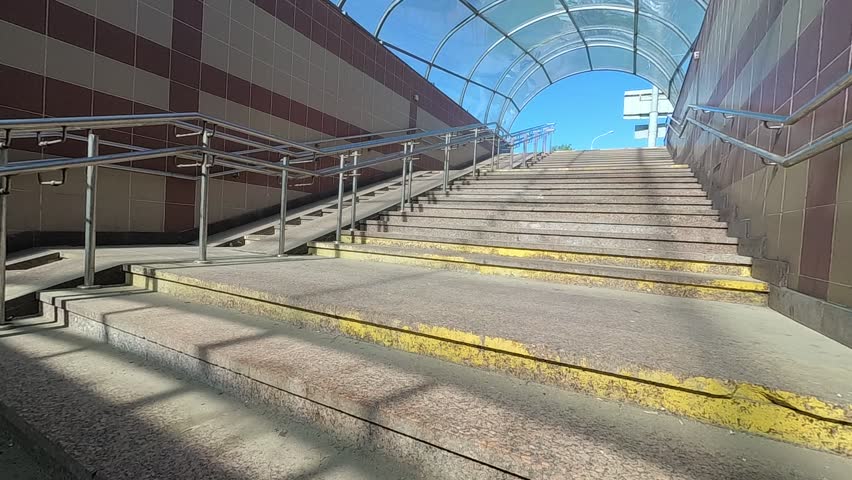underground pedestrian crossing. barrier-free environment. metal railing. Royalty-Free Stock Footage #1010554082