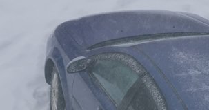 snow flakes fall on the car