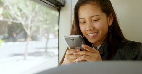 Teenage girl using mobile phone in the bus  วิดีโอสต็อก