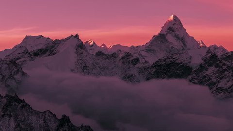 Greatness of nature concept: grandiose view of Ama Dablam peak (6812 m) at sunrise. Nepal, Himalayan mountains. Time lapse panorama.