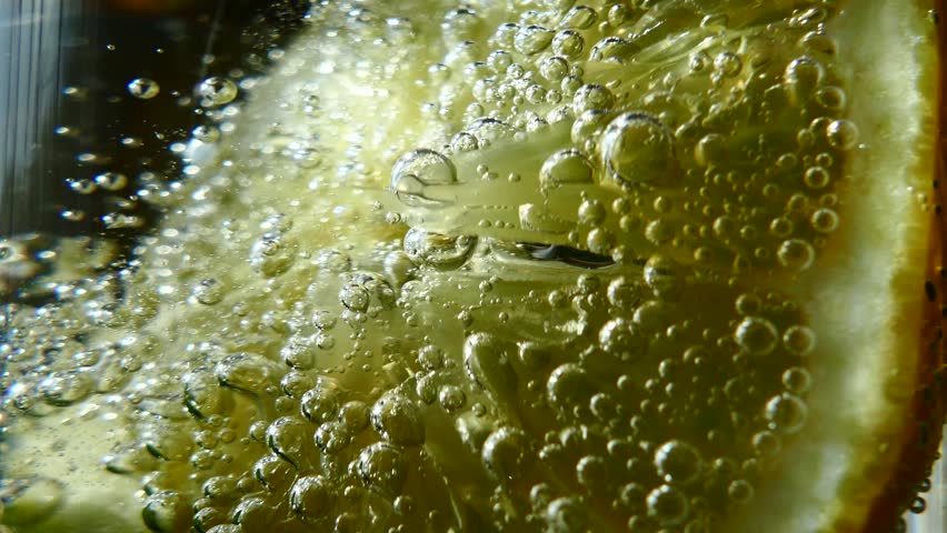 Refreshing Mojito cocktail. Non-alcoholic invigorating drink with lemon mint. Carbonated water in a glass with a tube is drunk. Royalty-Free Stock Footage #1010577584