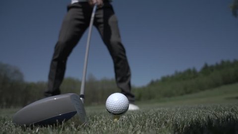 golf club hitting ball on the green artificial grass in slow motion