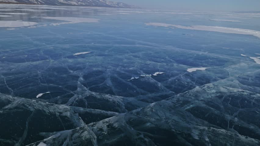 Family is ice skating at day. Girls to ride figure ice skates in nature. Mother and daughter riding together on ice in cracks. Outdoor winter fun for athlete nice winter weather. People on ice skates