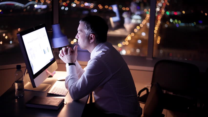 Stress from Working Late. Middle aged man stays late at the office to finish the project. He’s displeased and stressed, he’s nervously thinking of what to do to finish it. | Shutterstock HD Video #1010593871