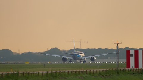 AMSTERDAM, THE NETHERLANDS - JULY 25, 2017: TUI Fly Boeing 787 Dreamliner PH-TFK approaching and landing at runway 06 Kaagbaan at sunrise. Shiphol Airport, Amsterdam, Holland