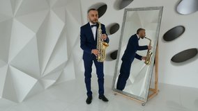 Man in suit playing saxophone on white background