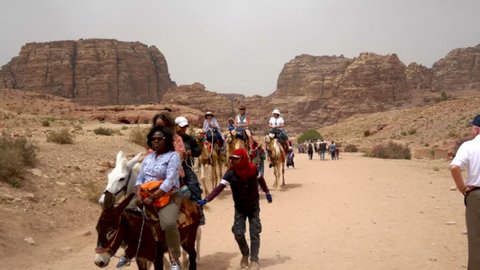 Petra, NA / Jordan - 04 21 2018: Petra, Jordan April 2018: Tourists ride camels and donkeys along the main trail