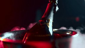 A bottle of expensive champagne is cooled in an ice bucket. Luxury. 4K. Food video