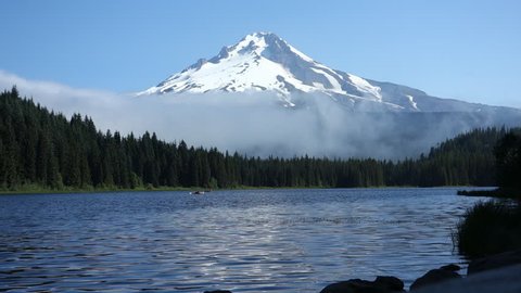 Beautiful view across Trillium Lake, as early morning mist drifts by Mount Hood