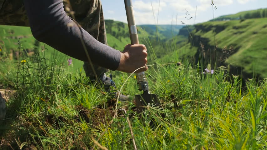 a man in the mountains digs