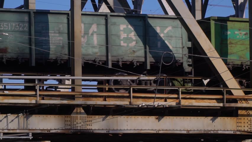 Freight train rides the steel bridge | Shutterstock HD Video #1010632493