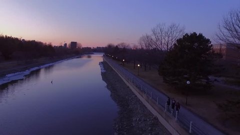 Low aerial tracking shot of a river at sunset.