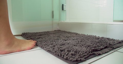 Woman drops towel as she enters shower