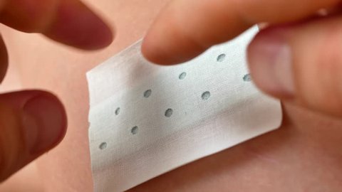 Use a cotton ball plating alcohol, paint around the wound disinfection. Person changes the dressing of wound at home. Cleaning lesion or wound on skin with alcohol for disinfect