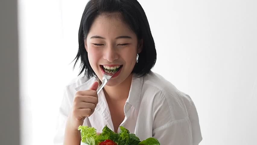 Asian Woman Eating Fresh Vegetables Stock Footage Video (100% Royalty-free)  1010646095 | Shutterstock