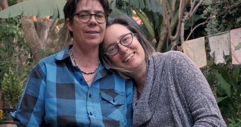 Authentic moment between a lesbian couple laughing and smiling together while looking at each other in the eyes – Video có sẵn