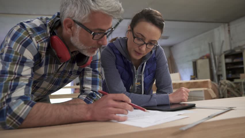 Wood industry technicians working together on project