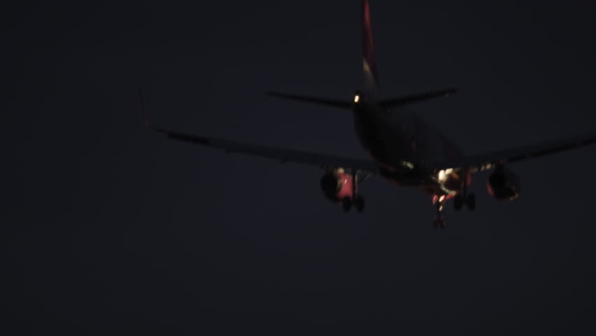 Evening video of a landing plane at the Warsaw Chopin Airport in Poland. Shot is taken after the sunset.