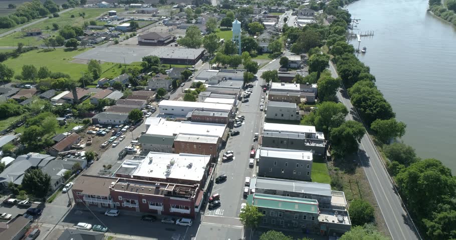 low flying over a field then ascending to heights while sun sets in the background