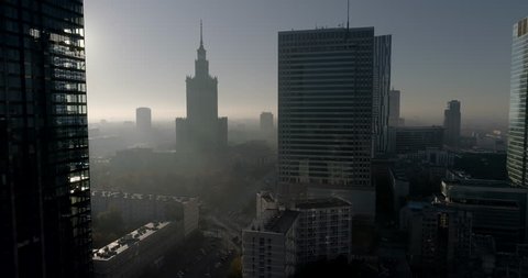 Drone footage of Warsaw city center focus on skyscrapers and Palace of Culture and Science. Shot is taken during a misty but sunny day in Polish capital city.

