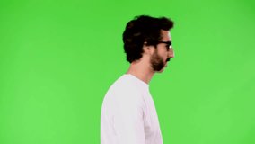 young crazy man with rare beard satisfied or happy expression. cutout against green chroma key background