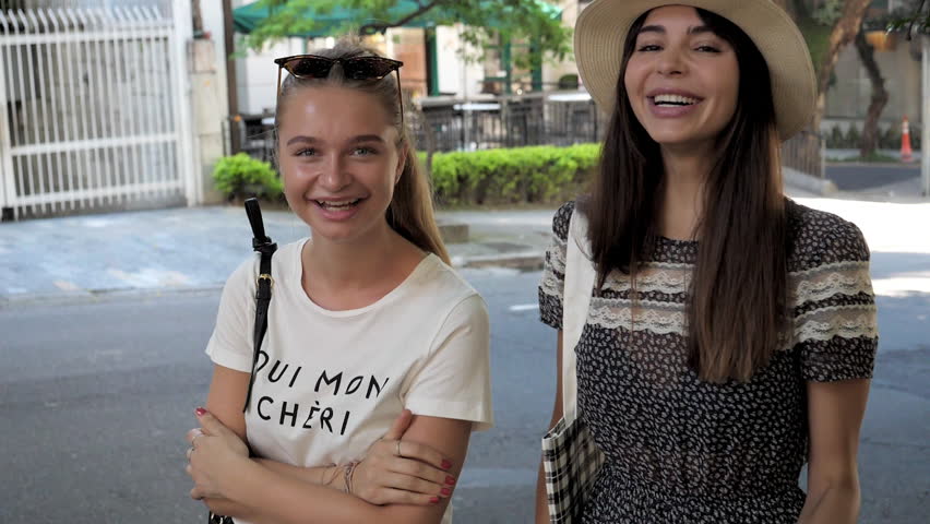 Pretty girls smiling in city