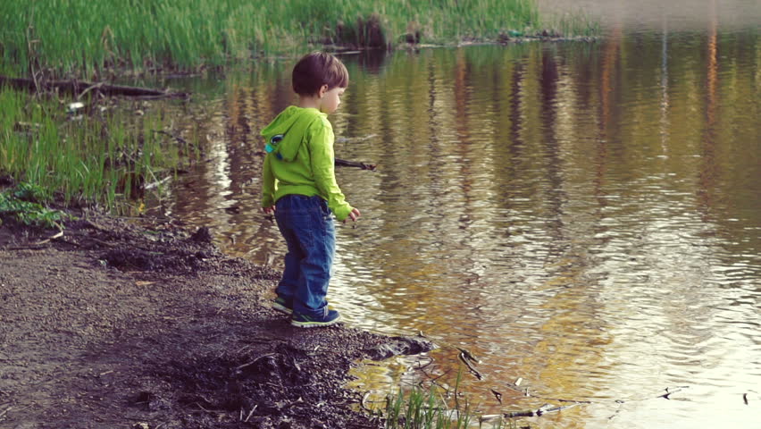 A child playing on the shore of thelake. Walks in the fresh air. A beautiful scenic place.