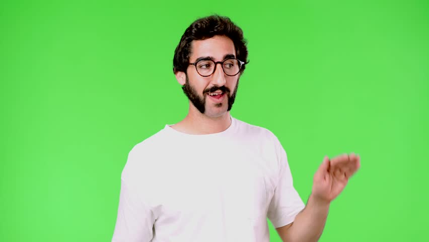young crazy man with a rare beard and trying to listen. cutout against green chroma key background