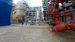 Process engineer to working in oil petroleum and chemical refinery plant. Wide angle lens video shoot