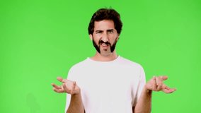 young crazy man with a rare beard confused. cutout against green chroma key background