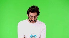 young crazy man with a rare beard and an alarm clock. cutout against green chroma background