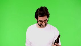 young crazy man with a rare beard and a beer. cutout against green chroma background