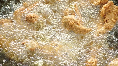 View footage of frying Chicken in boiling hot oil