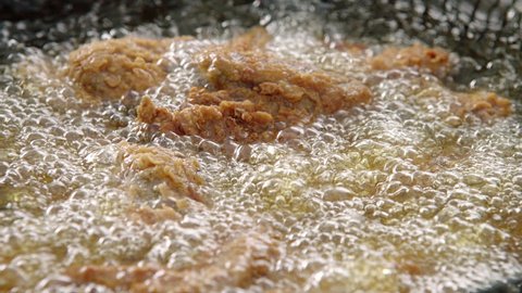 View footage of frying Chicken in boiling hot oil