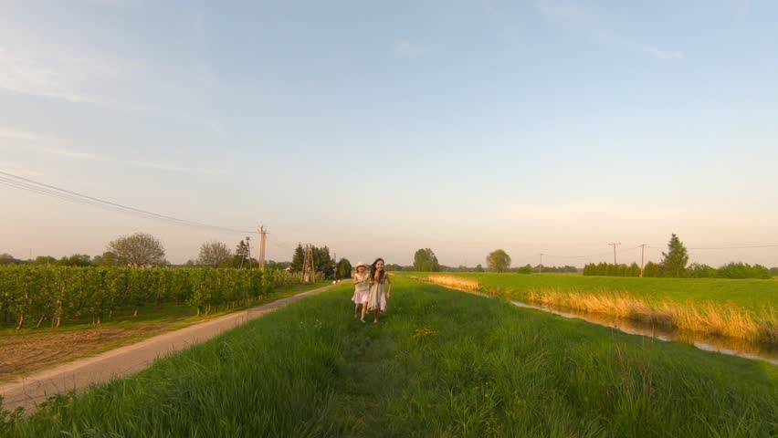 young girls spend time together in the meadow