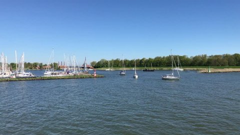 Pleasure boats sailing near the harbor of Enkhuizen, the Netherlands.