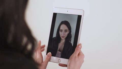 Girl is holding smartphone in her hands, scanning and recognizing the face, template.
