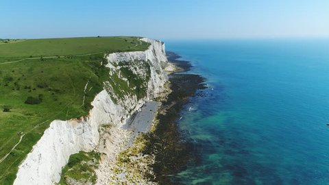 Aerial view of famous white cliffs of Dover, clear blue sky - English Channel, England, Great Britain from above, 4k UHD