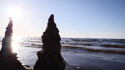 Sand castles at Baltic sea shore slow motion