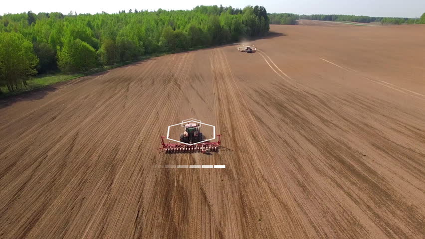 Two tractors going in the opposite direction and cultivating land with using an advanced autopilot and radar system, sensor and control of the surrounding space detectors. 4k