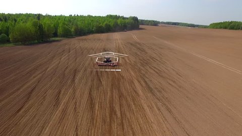 Tractor cultivating land with using an advanced autopilot and radar system, sensor and control of the surrounding space detectors. 4k