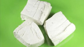 Tofu raw on a green background